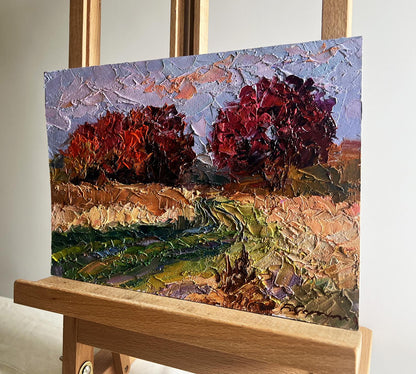 Oil painting Crimson autumn in the forest by Boris Serdyuk on easel