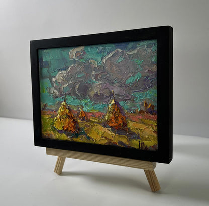 Oil painting Cloudy horizon by Oleksiy Ivanyuk: golden haystacks under teal sky