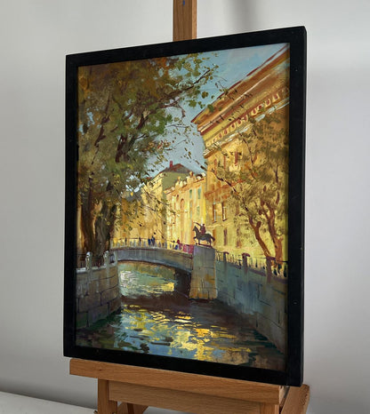 Framed oil painting of sunlit canal by Yuriy Suprunchuk in black frame