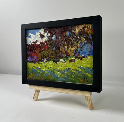 Vibrant impressionist oil painting of cows on meadow by Oleksiy Ivanyuk in black frame