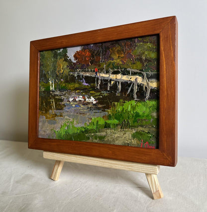 Rustic impressionist oil painting by Oksana Ivanyuk: ducks on lake near bridge