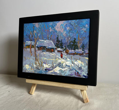 Black-framed Oil painting On a frosty day by Oksana Ivanyuk snowy village scene