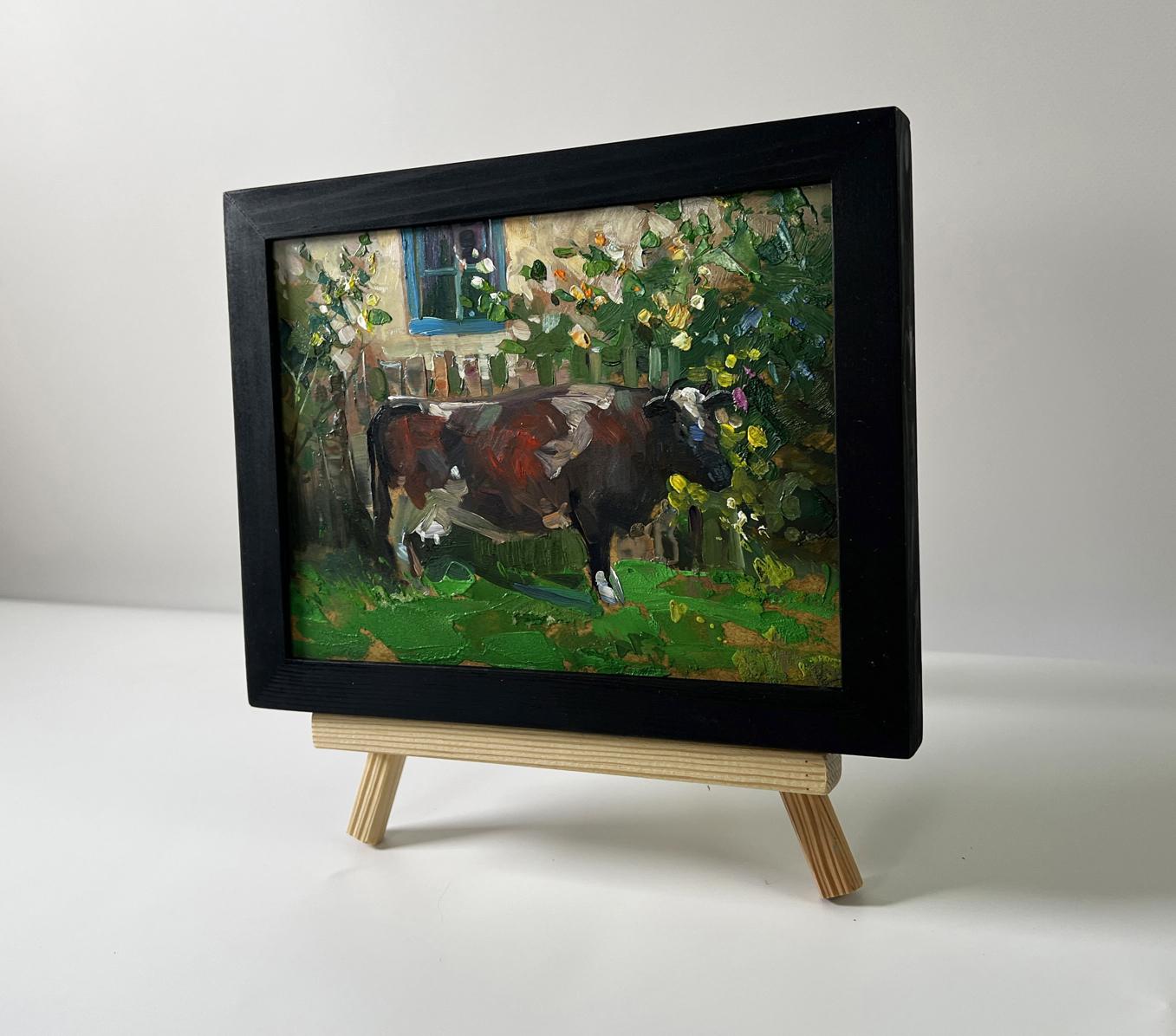 Framed oil painting of brown white cow near house by Yuriy Suprunchuk