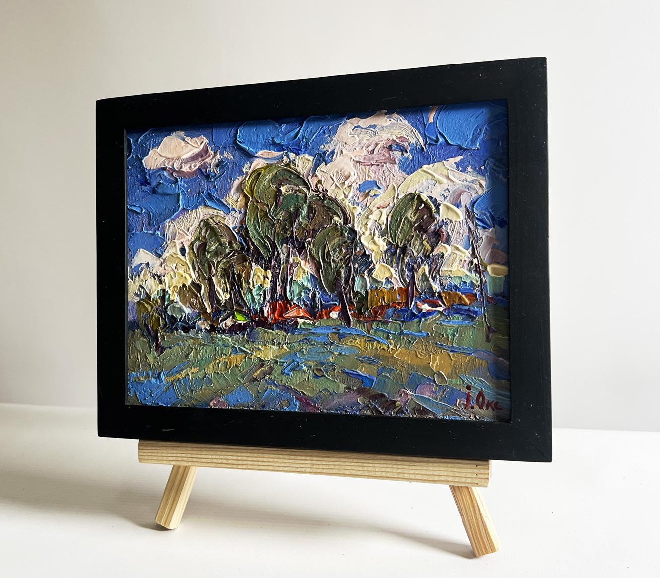 Oil painting by Oksana Ivanyuk: Clouds over village, impasto blue skies, green trees