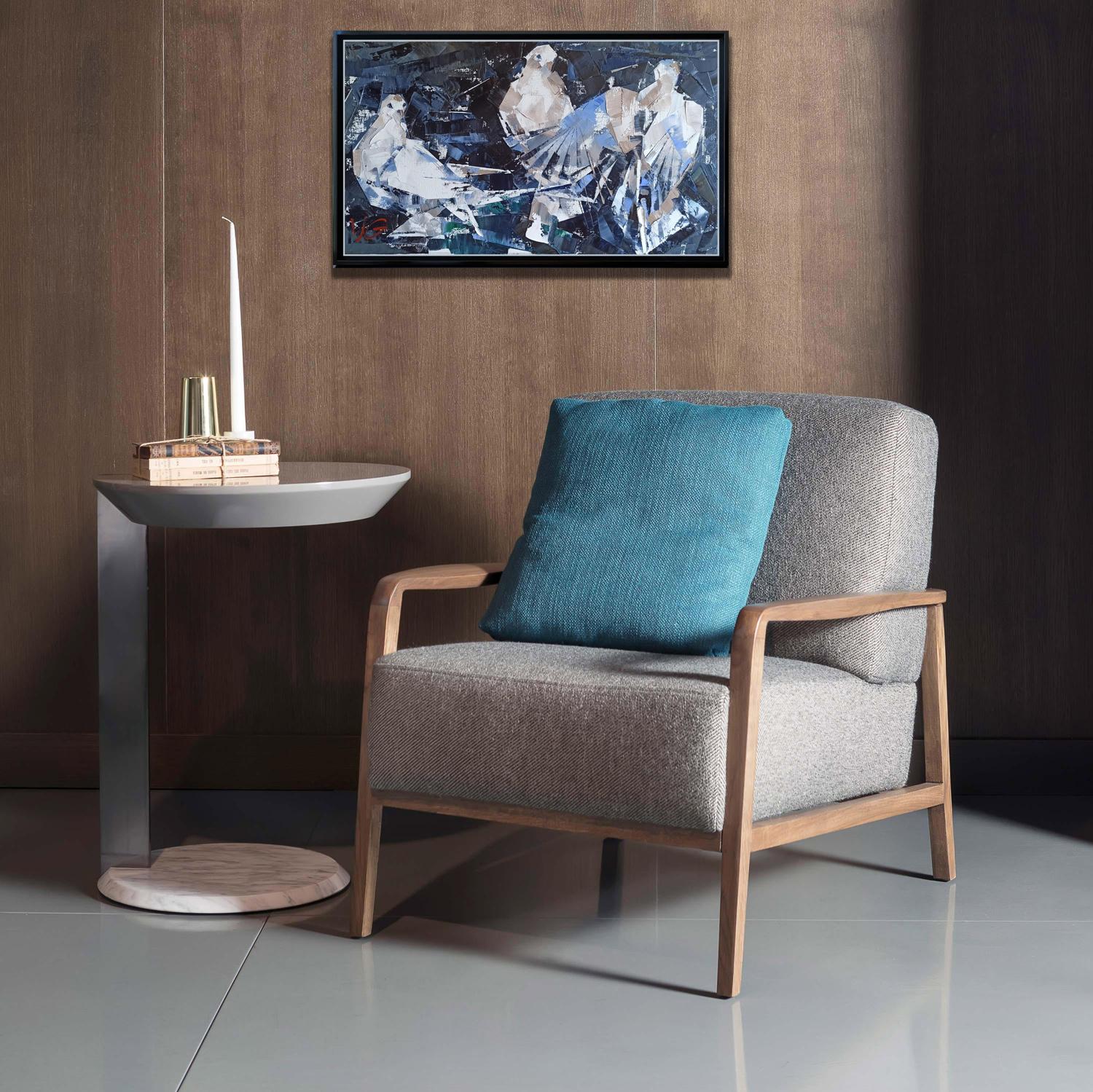 Gray upholstered armchair with wooden frame, teal cushion, Oil painting Under the wings Volodymyr Gluhomanyuk