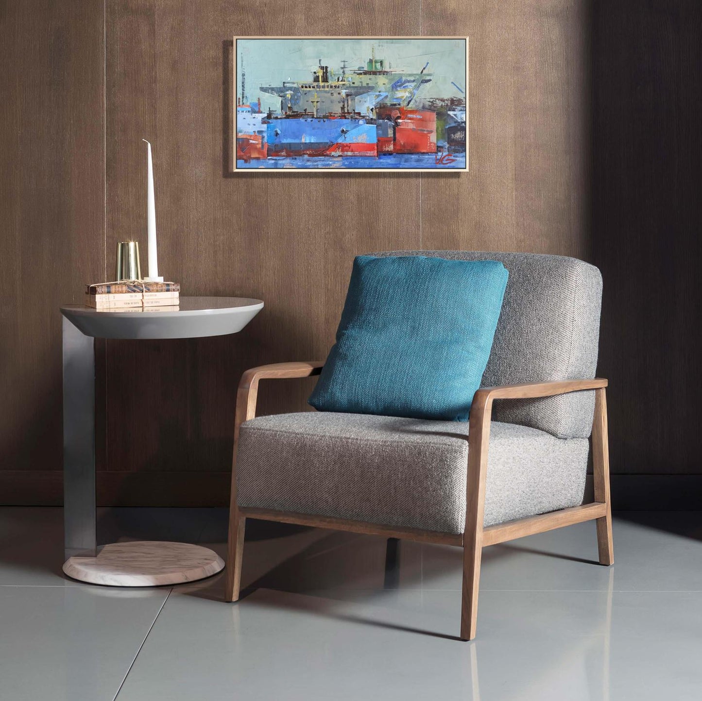 Gray armchair with teal cushion beside Oil painting Big ships by Volodymyr Gluhomanyuk