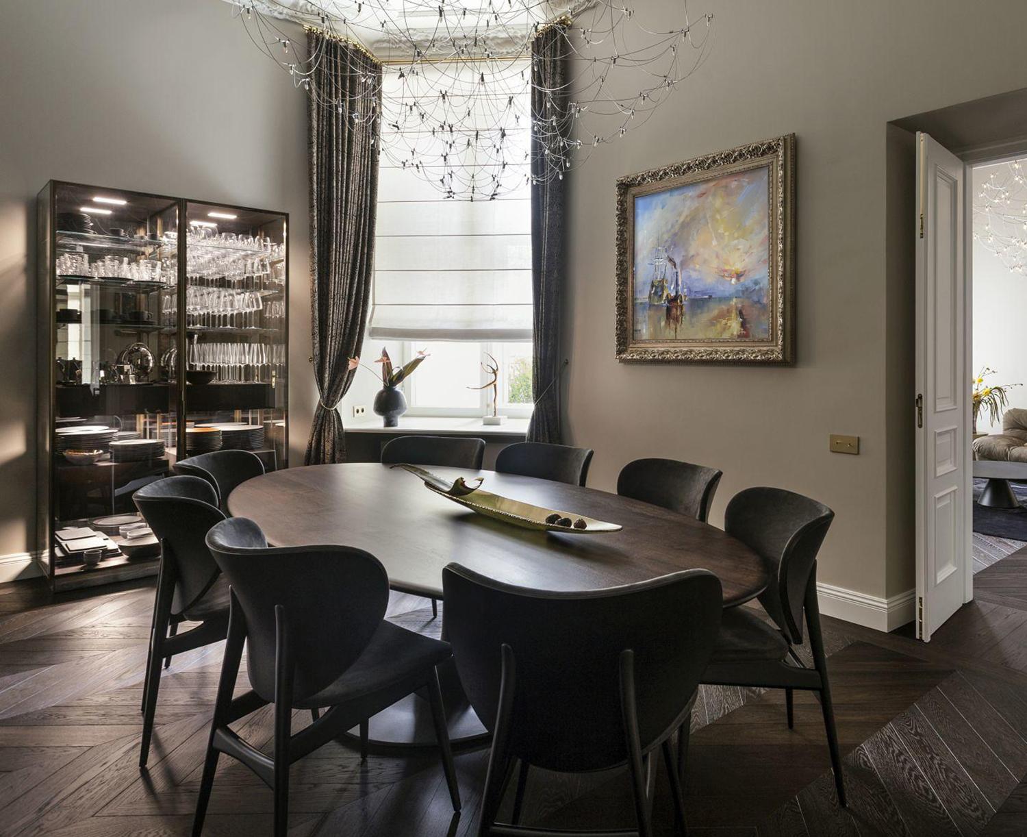 Oil painting of dark wood oval dining table with sleek black chairs by Shining Volodymyr Gluhomanyuk