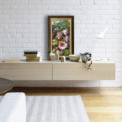 Framed pink hollyhocks oil painting by Volodymyr Gluhomanyuk in dark wood frame