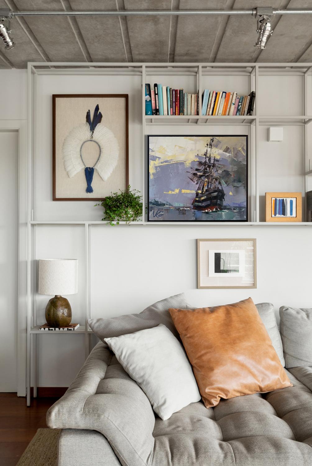 Gray tufted sofa with white pillow and orange leather accent pillow