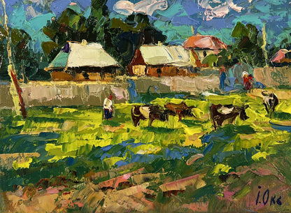Vibrant impressionist oil painting by Oksana Ivanyuk: cows graze outside rural village