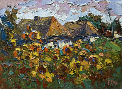 Oil painting of sunlit field with flowers by Oksana Ivanyuk