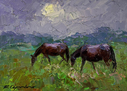 Oil painting by Boris Serdyuk: two dark brown horses grazing in green field at twilight