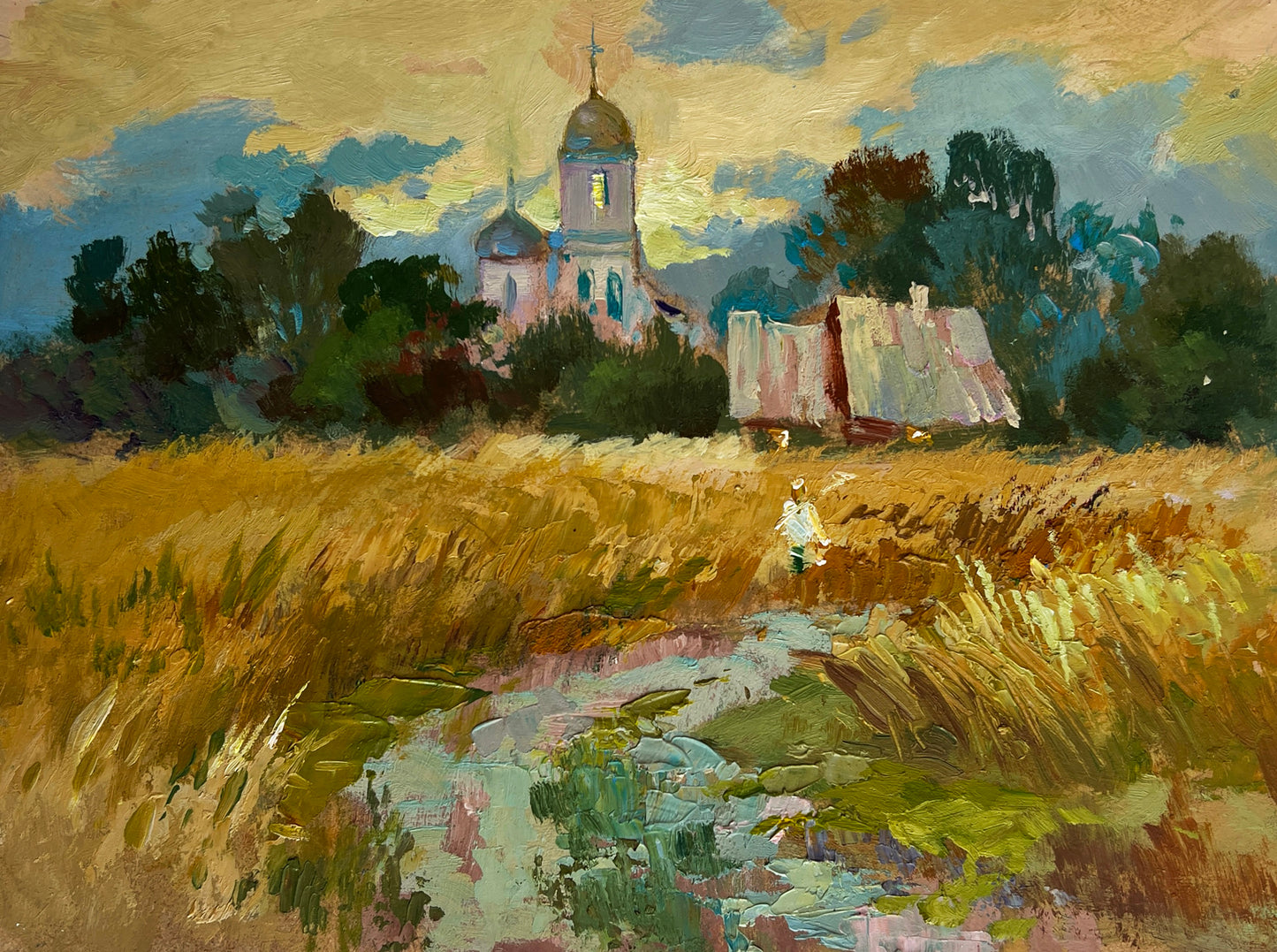 Serene impressionistic golden wheat field with church, barn by Yuriy Suprunchuk