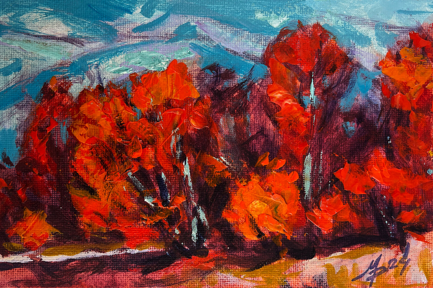 Vibrant orange red autumn trees by Mykhailo Patskan against blue sky
