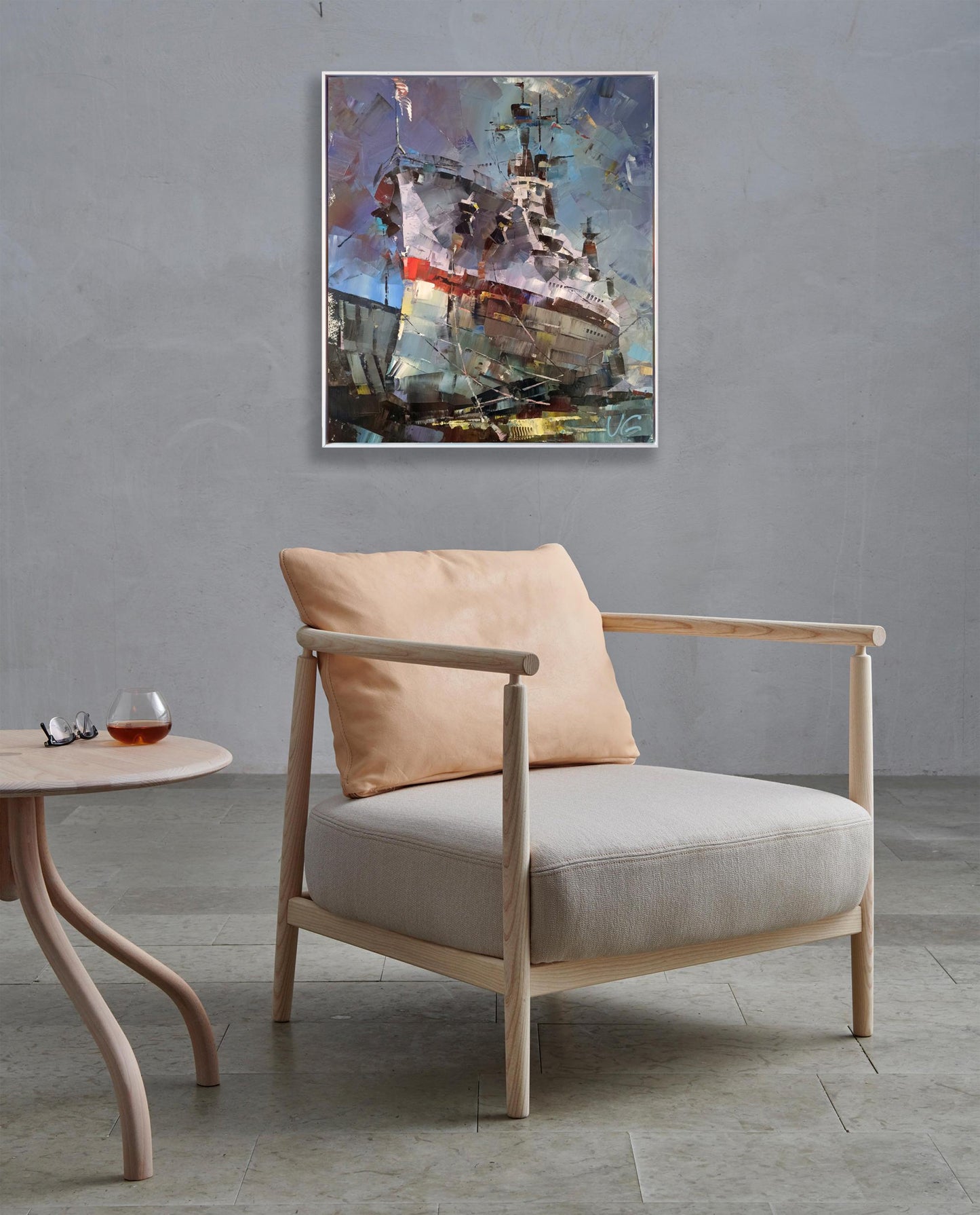 Light wood armchair with beige seat beside USS Texas BB-35 oil painting