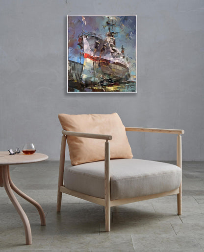 Light wood armchair with beige seat beside USS Texas BB-35 oil painting