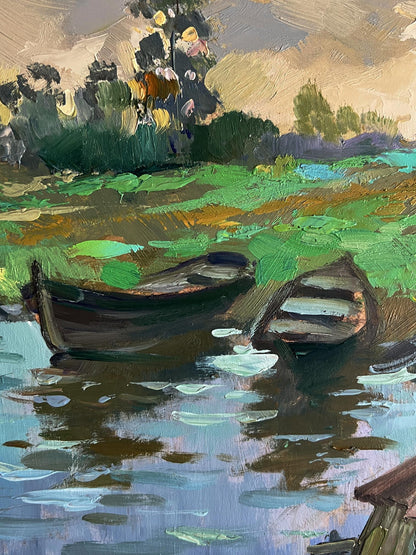 Oil painting of village river with two dark wooden boats by Yuriy Suprunchuk