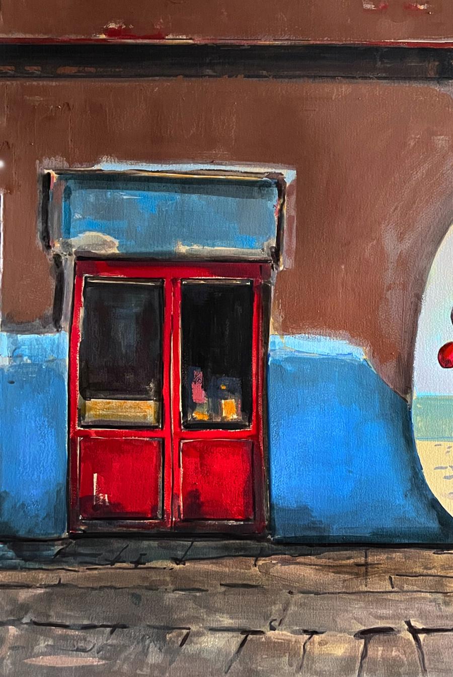 Vibrant red double door with glass panels in blue storefront by Juan Angel Gonzalez de la Calle