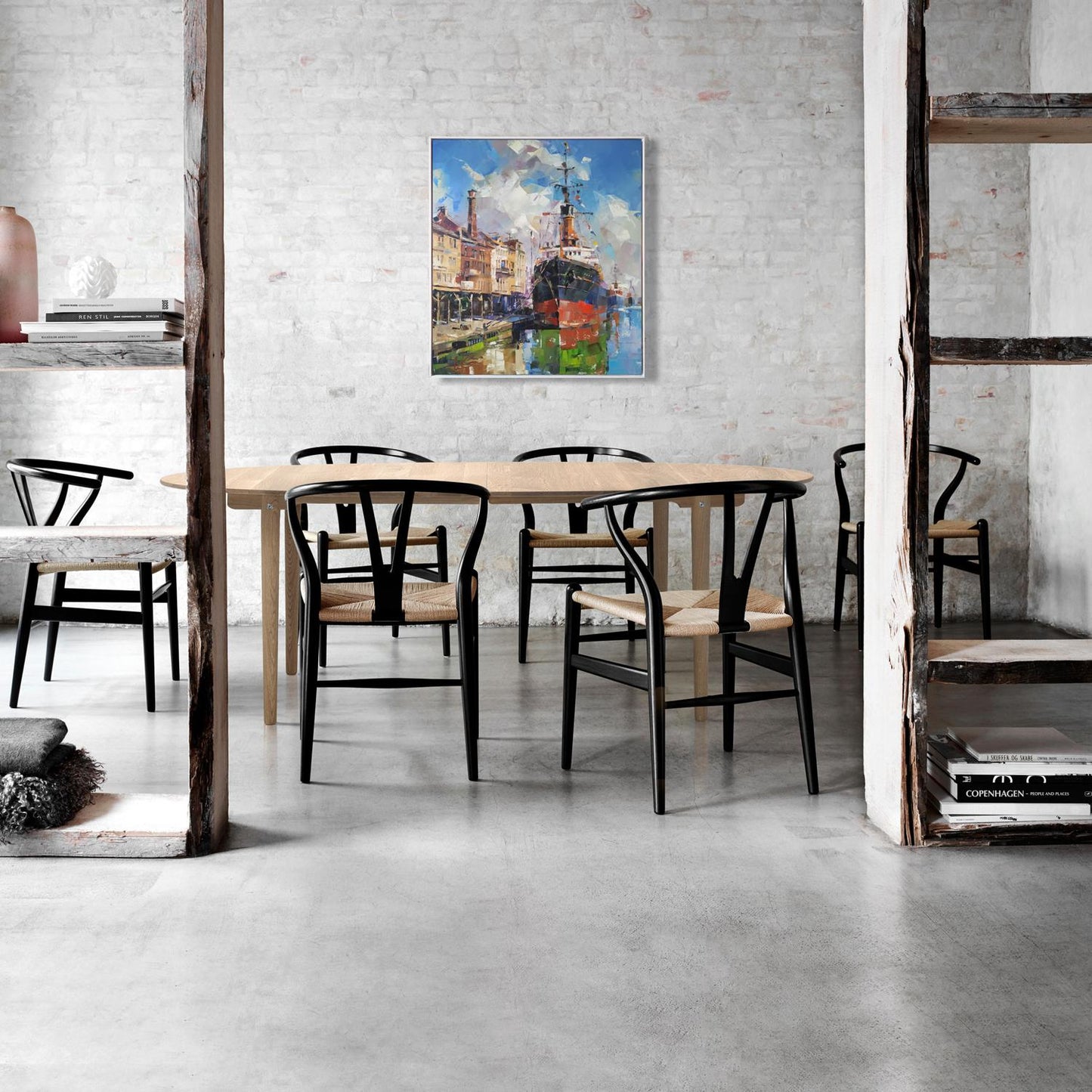 Black and light wood wishbone chairs with woven seats in Oil painting Between two banks Volodymyr Gluhomanyuk