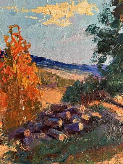 Oil painting of house on hill by Boris Serdyuk with orange foliage and blue sky