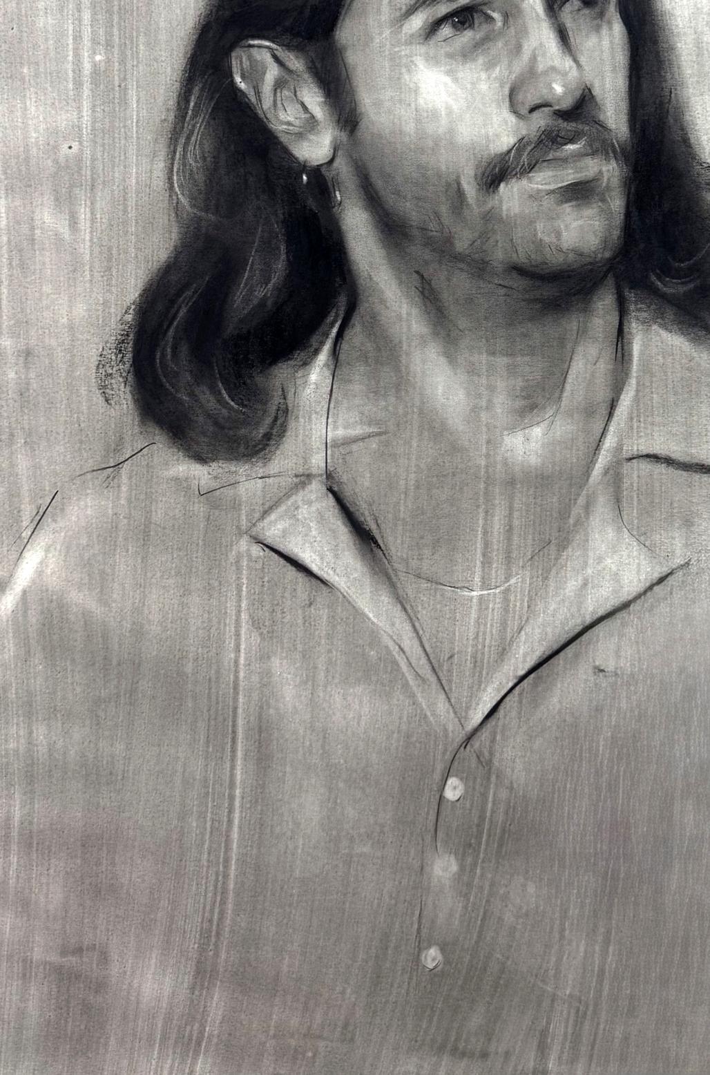 Charcoal portrait sketch of Alessio Annam Butt, long hair, mustache