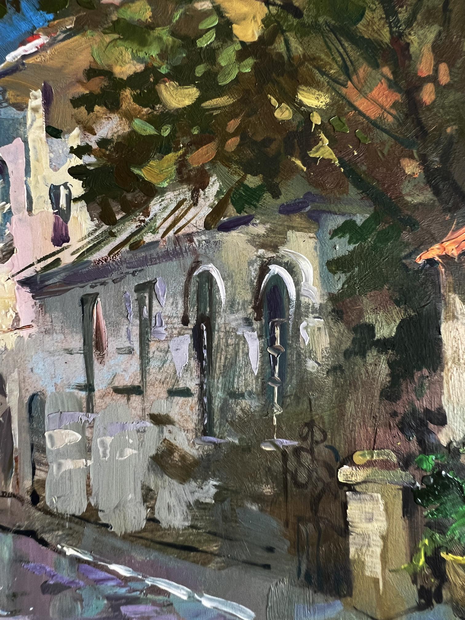 Oil painting by Yuriy Suprunchuk: impressionistic stone building with arched windows, laundry, trees