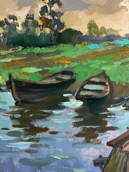 Oil painting of village river with two weathered boats by Yuriy Suprunchuk