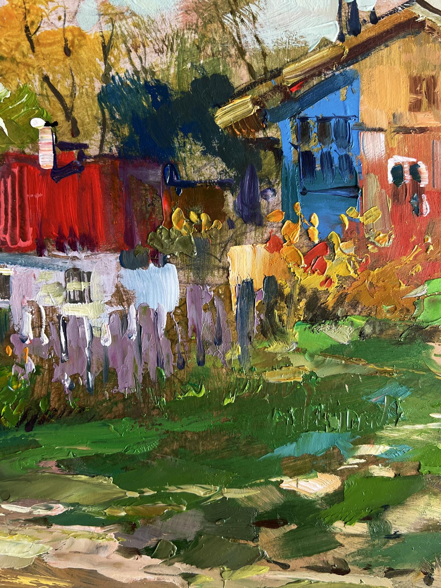 Oil painting of quiet village street by Yuriy Suprunchuk with blue red house