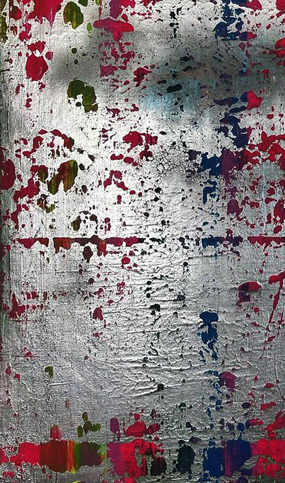 Silver metallic surface with colorful paint splatters by Olga Melezhik