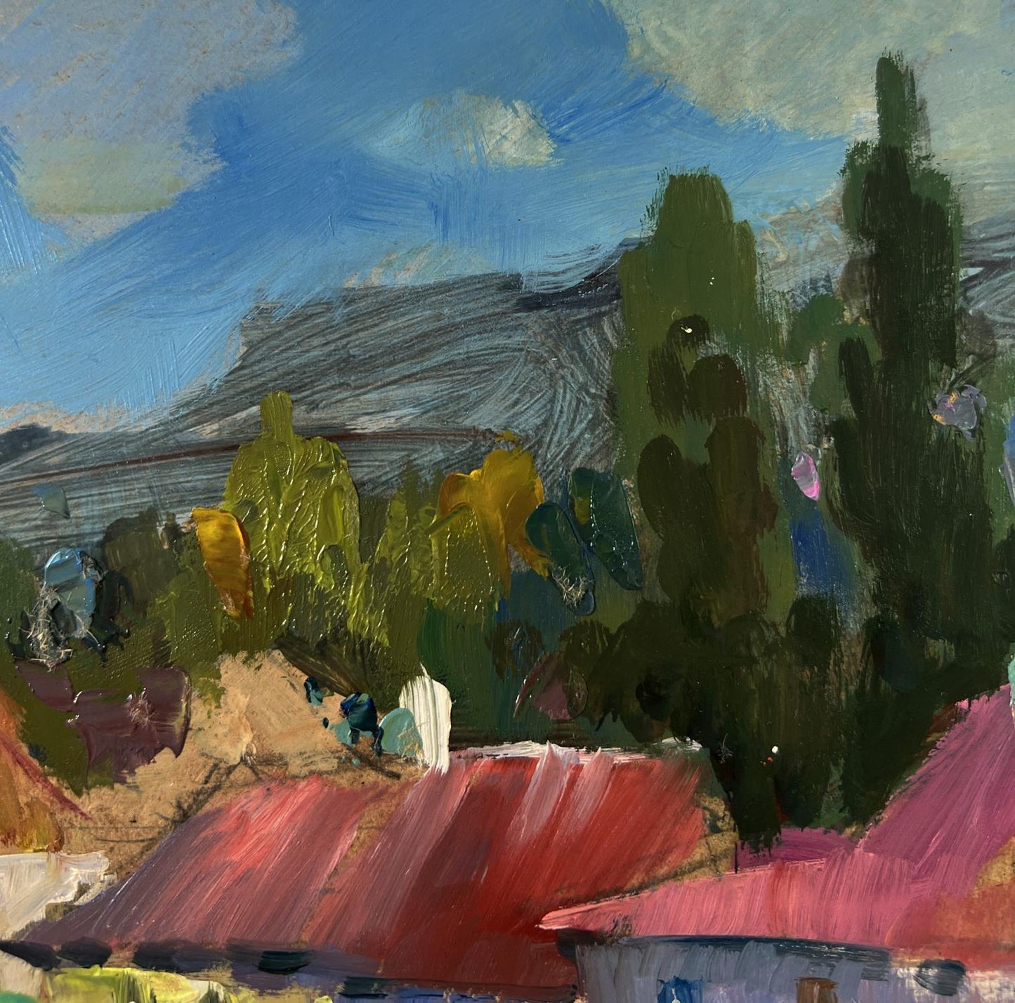 Oil painting of vibrant red roofed village among mountains by Yuriy Suprunchuk