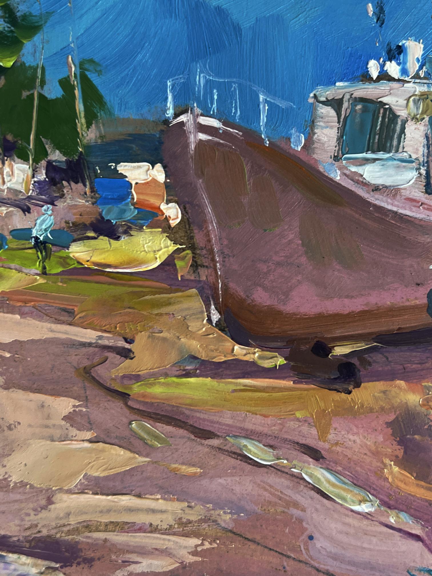 A rustic brown wooden boat with a weathered hull rests on a colorful, textured shoreline.