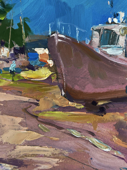 A rustic brown wooden boat with a weathered hull rests on a colorful, textured shoreline.
