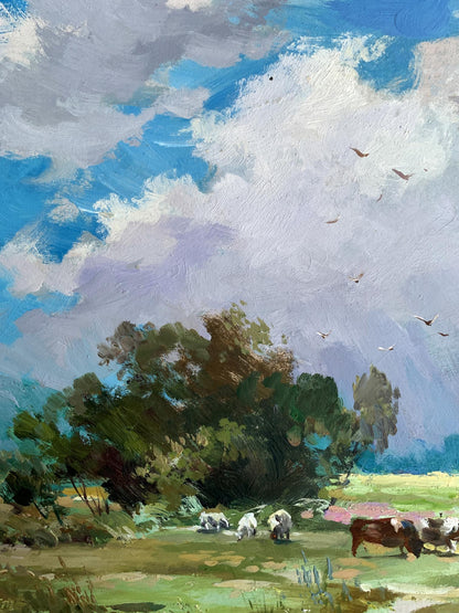 Oil painting by Yuriy Suprunchuk: cows grazing in lush field under blue sky with clouds