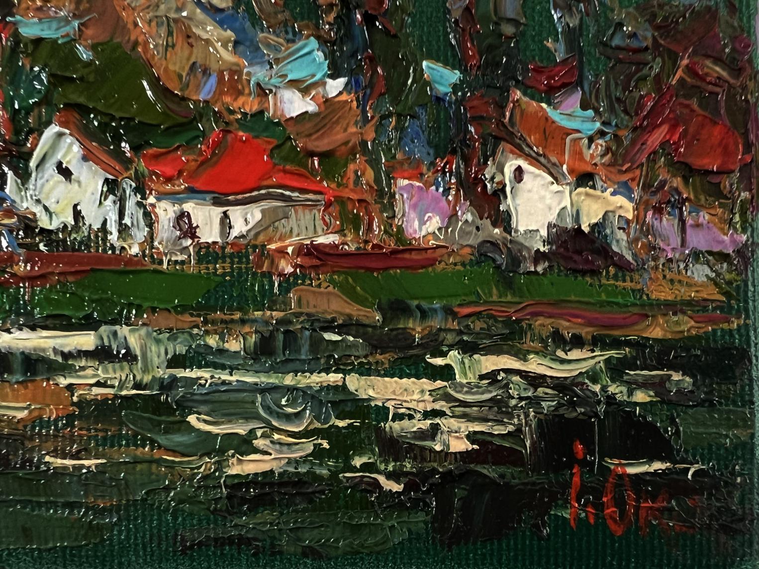 Oil painting by Oksana Ivanyuk: village with white buildings, red roofs in lake reflection