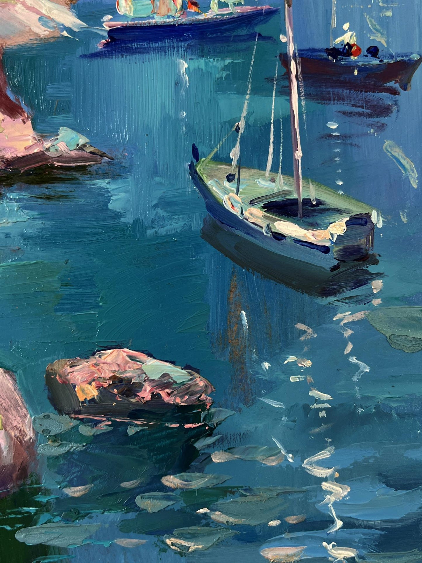 Impressionistic oil painting of small green-hull sailboat on rocky shore by Yuriy Suprunchuk
