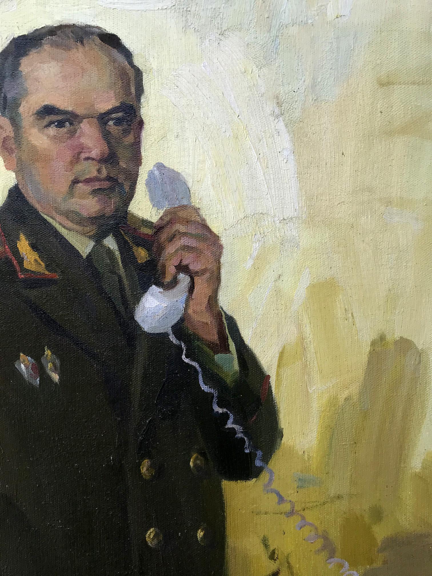 Hand holding vintage white phone receiver on KGB Major General Koval portrait