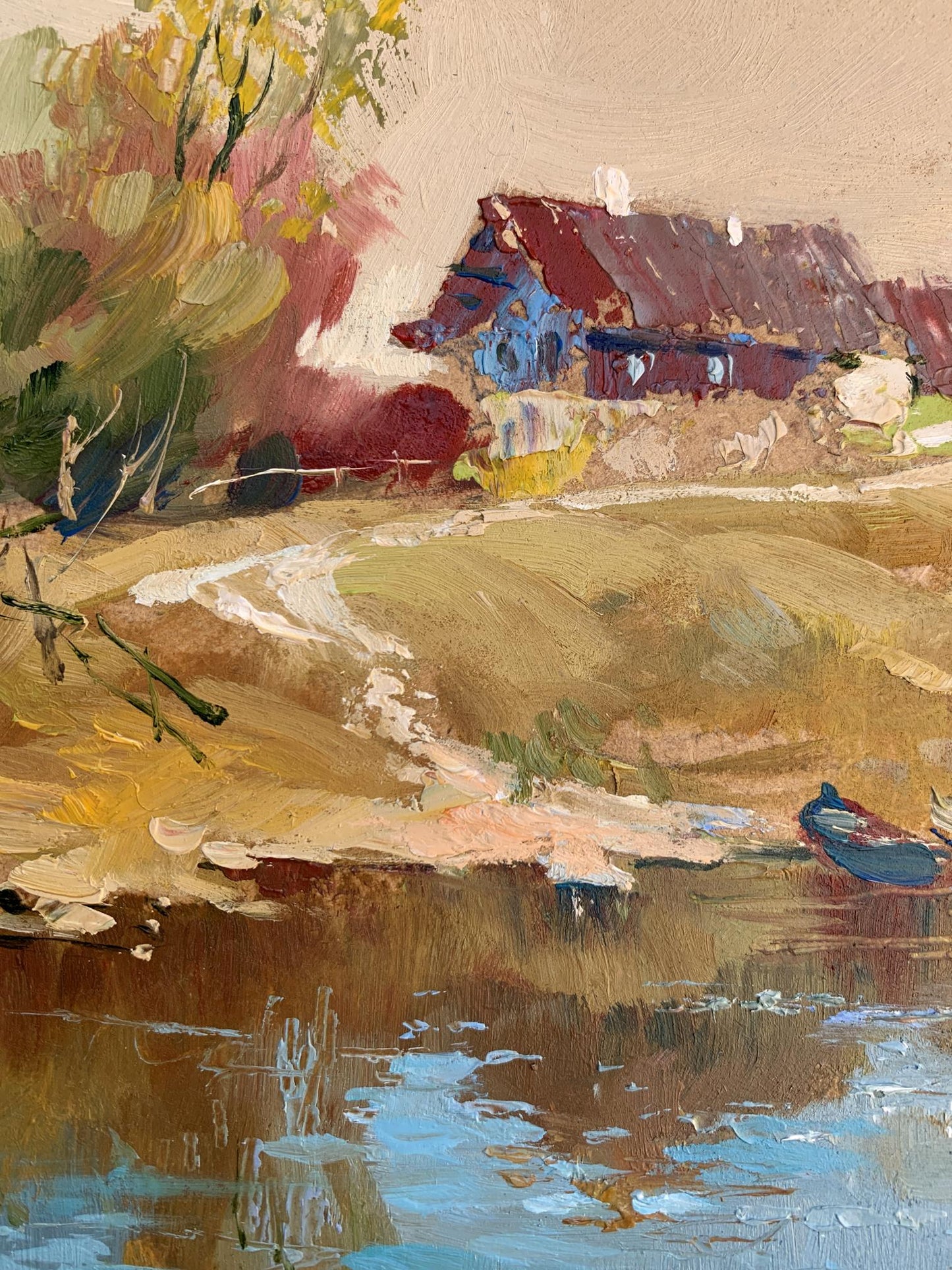 Oil painting by Yuriy Suprunchuk: rustic blue red house amid autumn trees by water