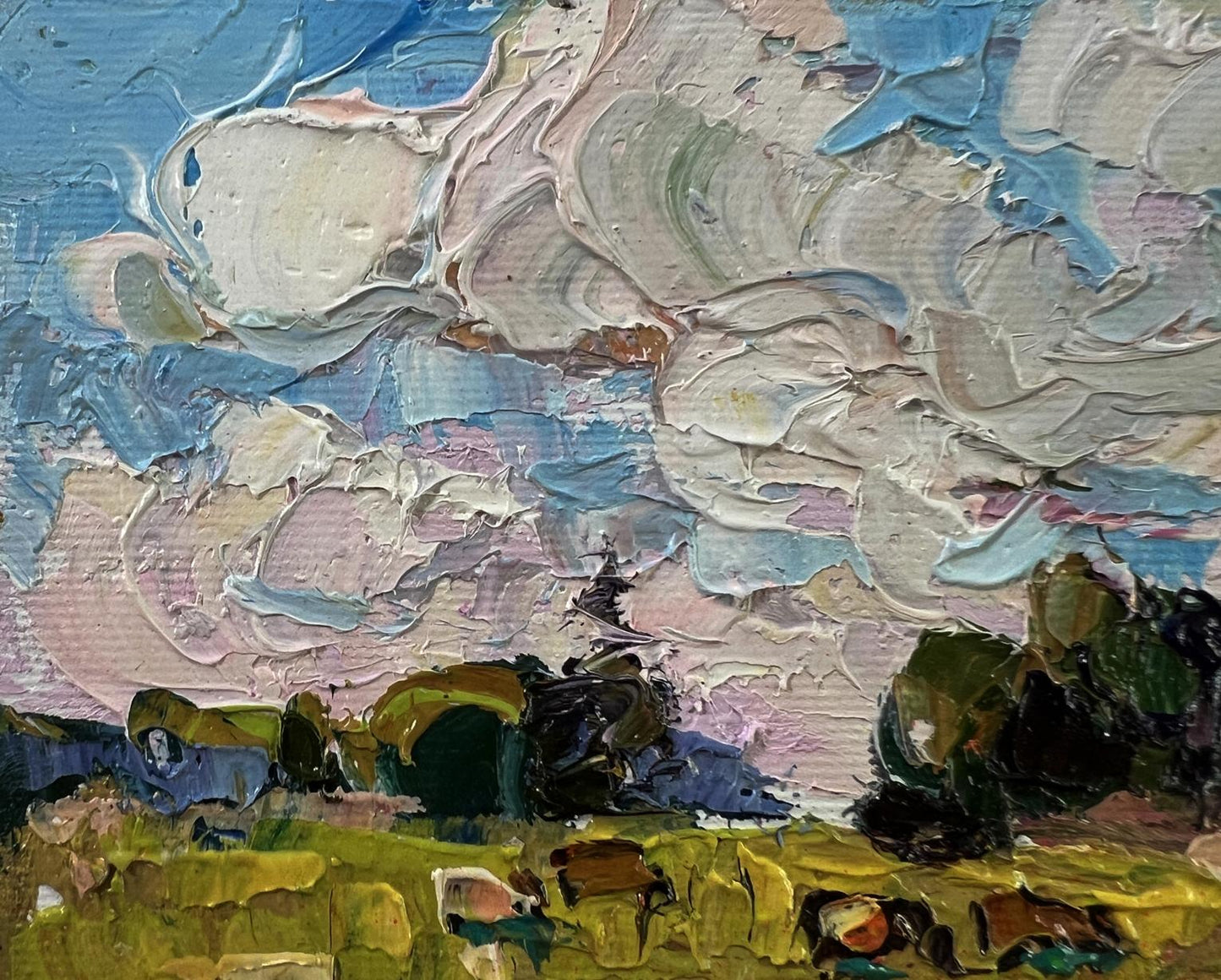 Impasto oil painting by Oksana Ivanyuk: daytime field with swirling blue clouds