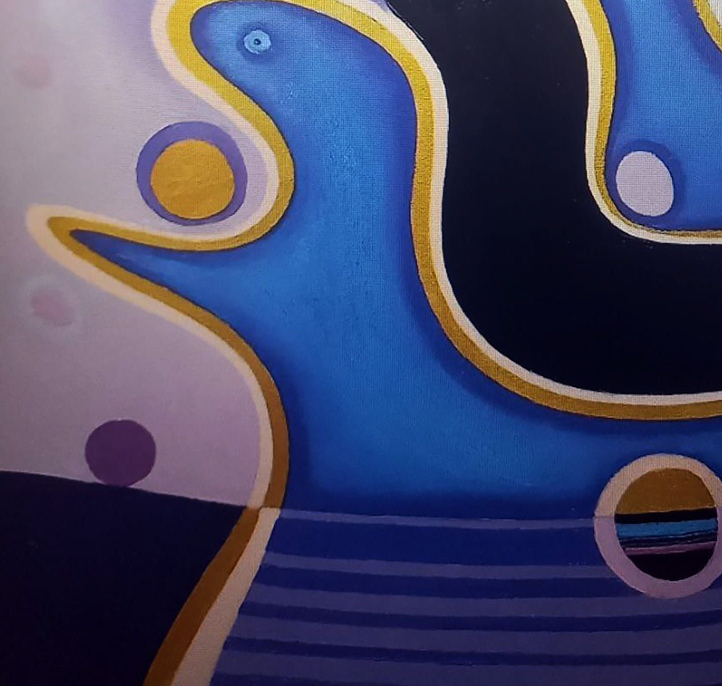 Abstract canvas painting featuring bold blue, black, and gold shapes with purple accents.