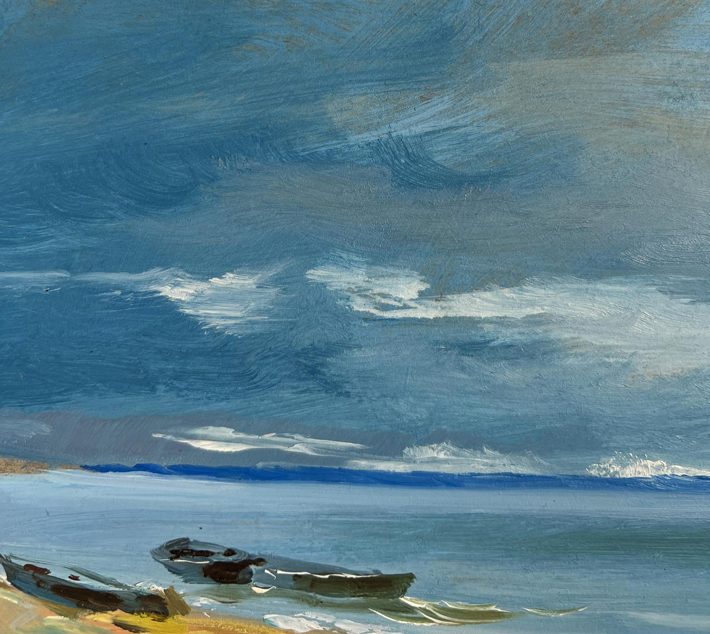 Oil painting The call of distant waves by Yuriy Suprunchuk: rowboats on shore under swirling sky