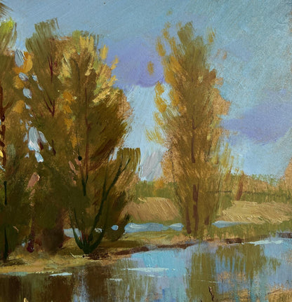 Oil painting of autumnal trees by river near village by Yuriy Suprunchuk