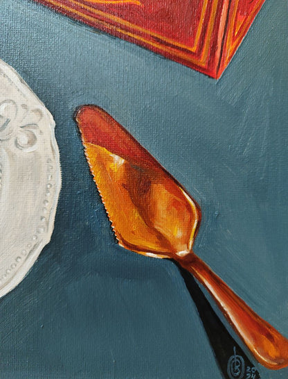 Polished copper serrated cake server by Oksana Sklym on ornate white plate