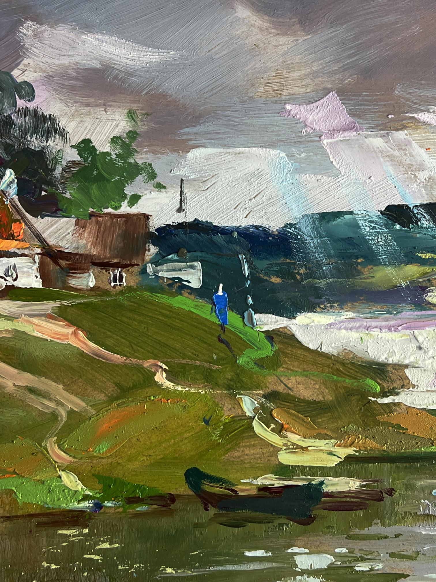Vibrant impressionistic oil painting of lone blue figure by river near village by Yuriy Suprunchuk