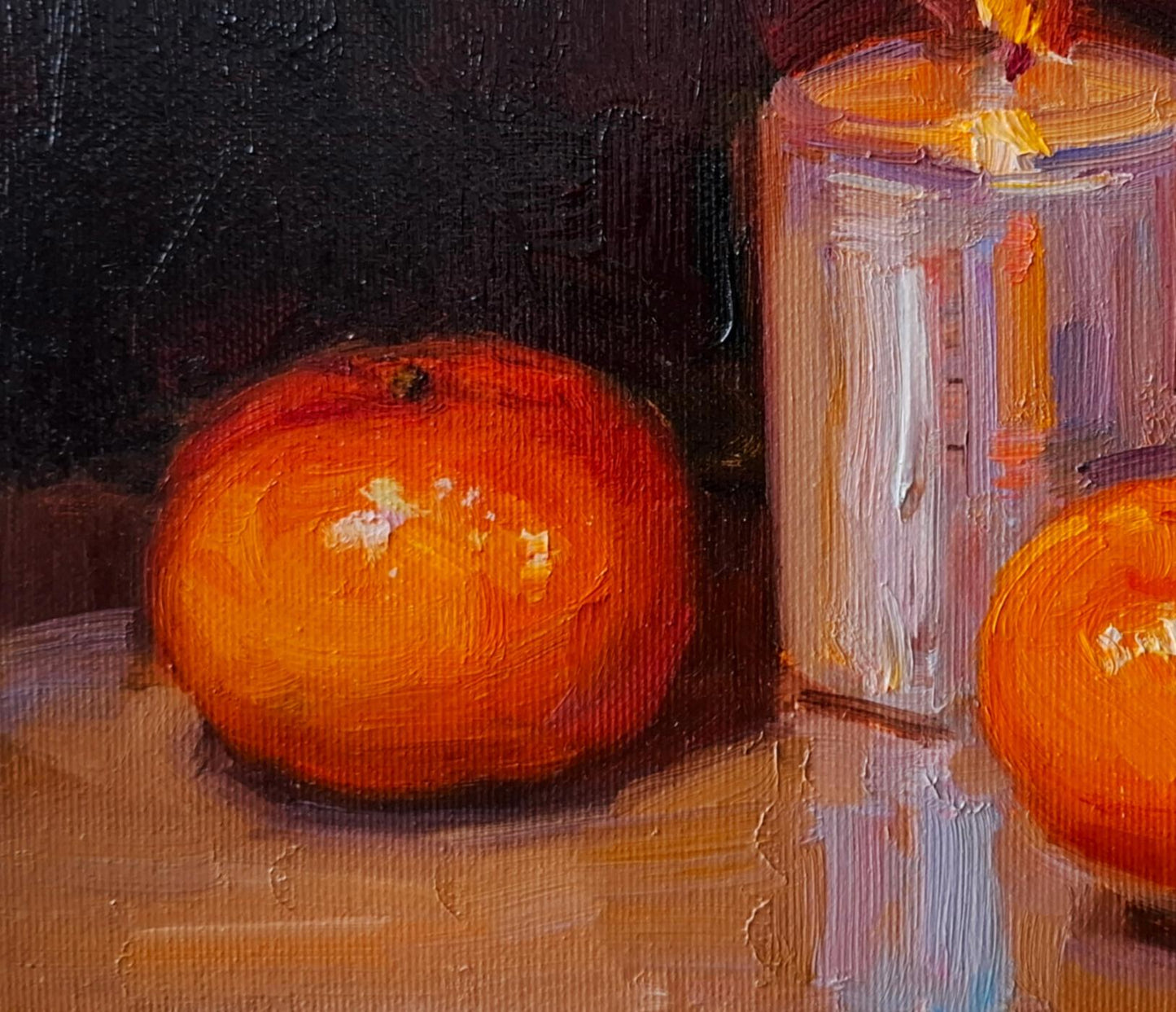 Oil painting of vibrant orange tangerine and candle by Vyacheslav Pereta