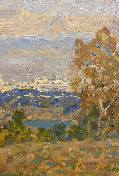Oil painting of coastal landscape with city in distance by Georgy Kolosovsky