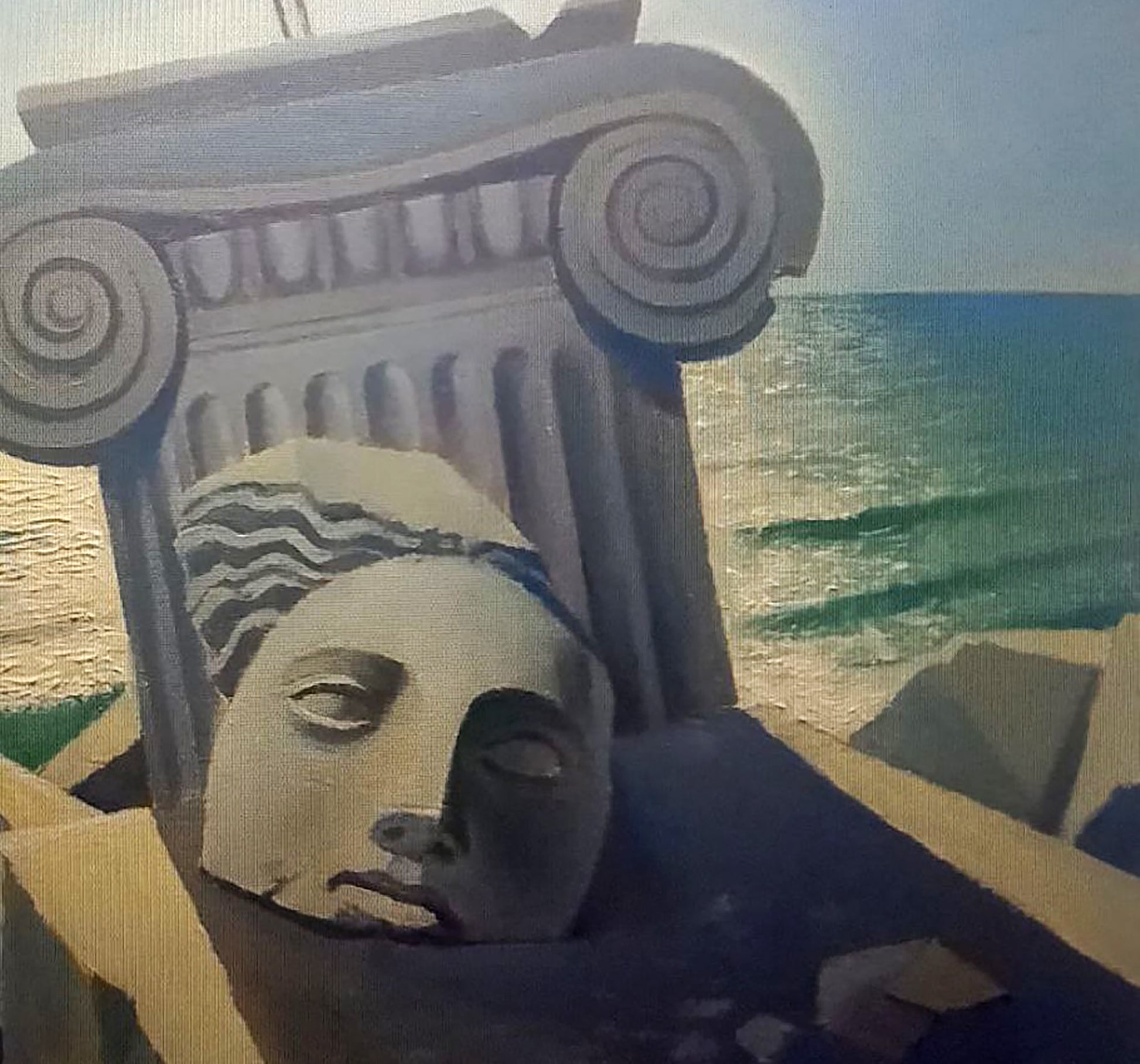 Weathered stone sculpture of classical female face by Alexander Strashevich with ocean backdrop