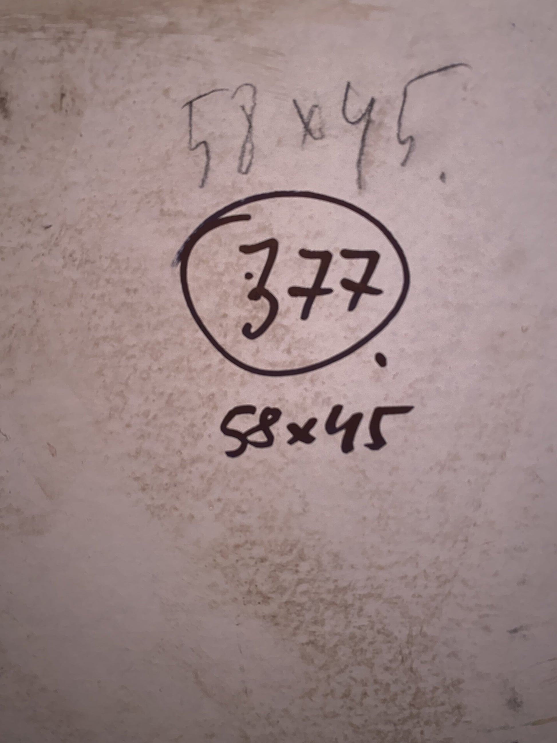 Back of oil painting with sea views showing handwritten measurements and circled 377 on textured surface