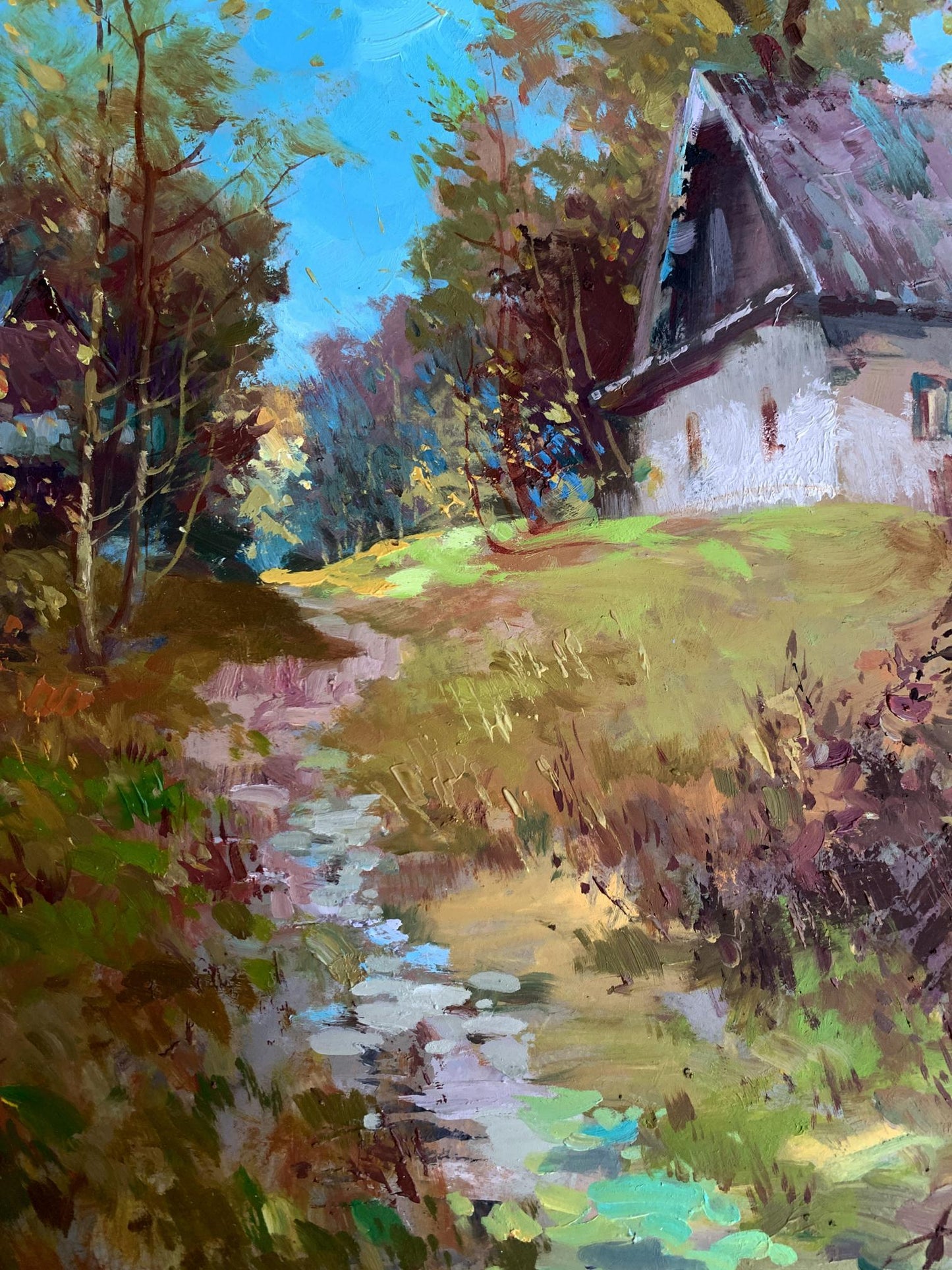 Oil painting of rustic white cottage by Yuriy Suprunchuk among autumn trees