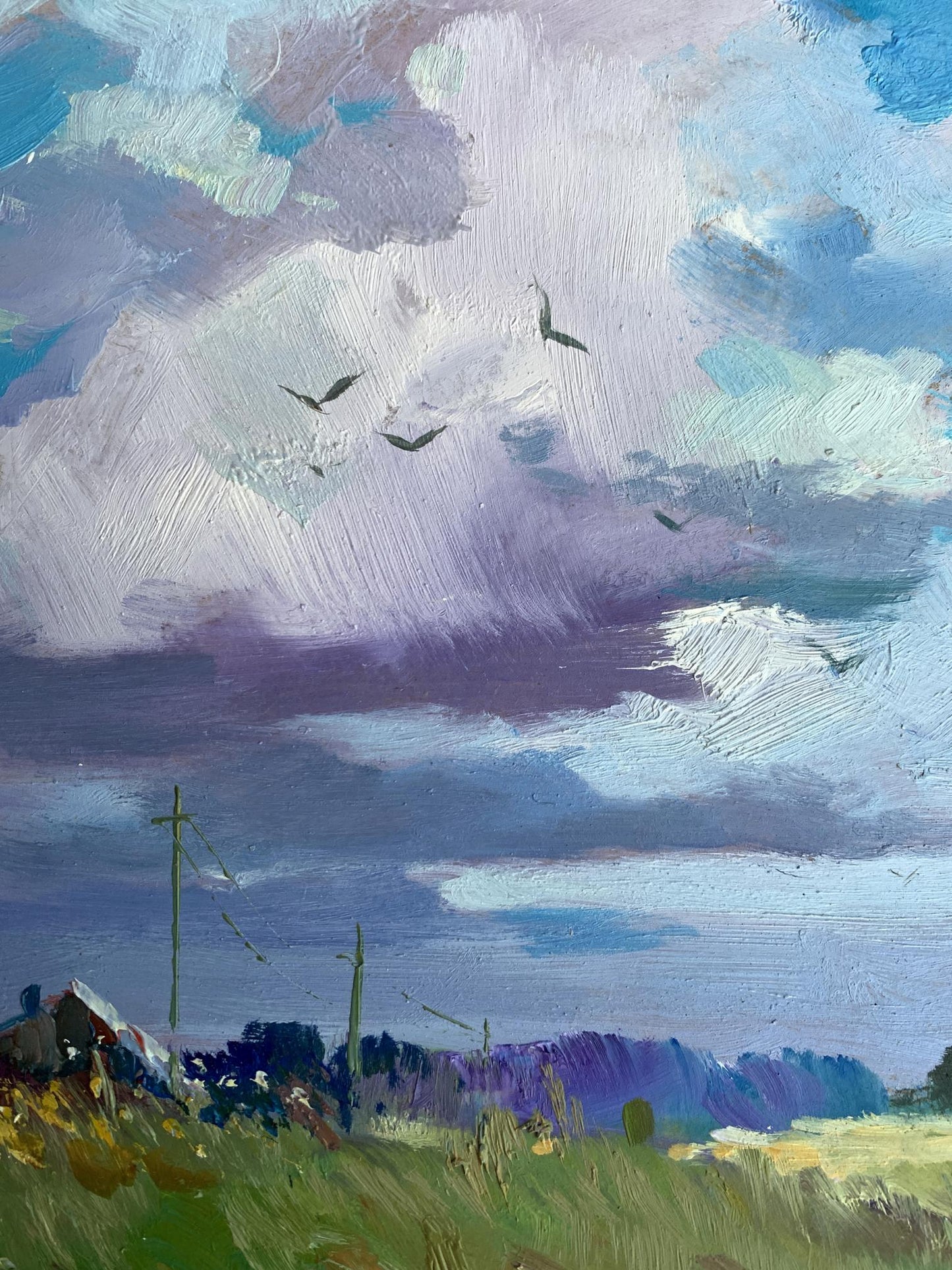 Textured oil painting by Yuriy Suprunchuk of dramatic purple-blue sky over village field
