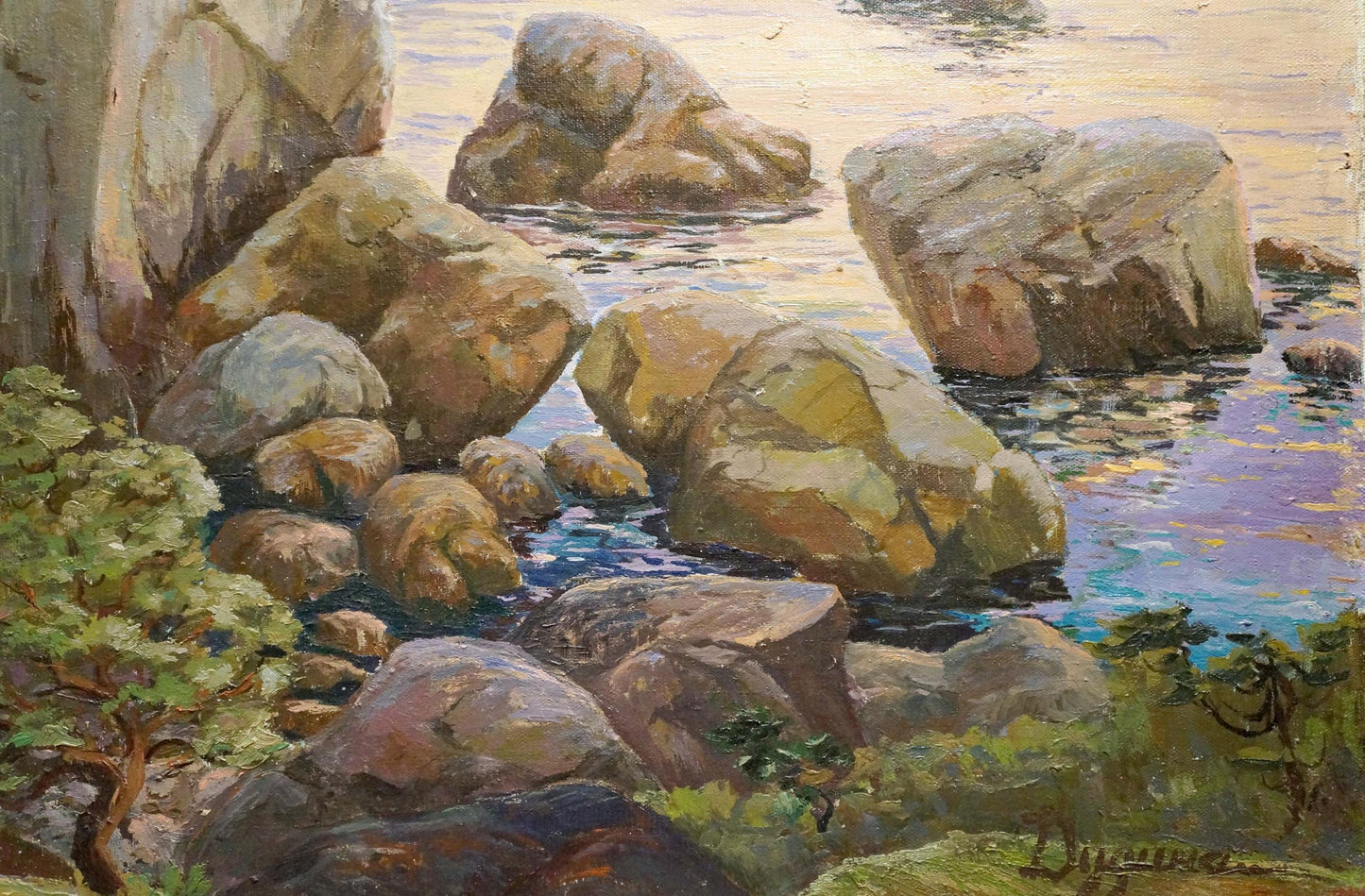 Oil painting of rugged sunlit coastal rocks with foliage and water